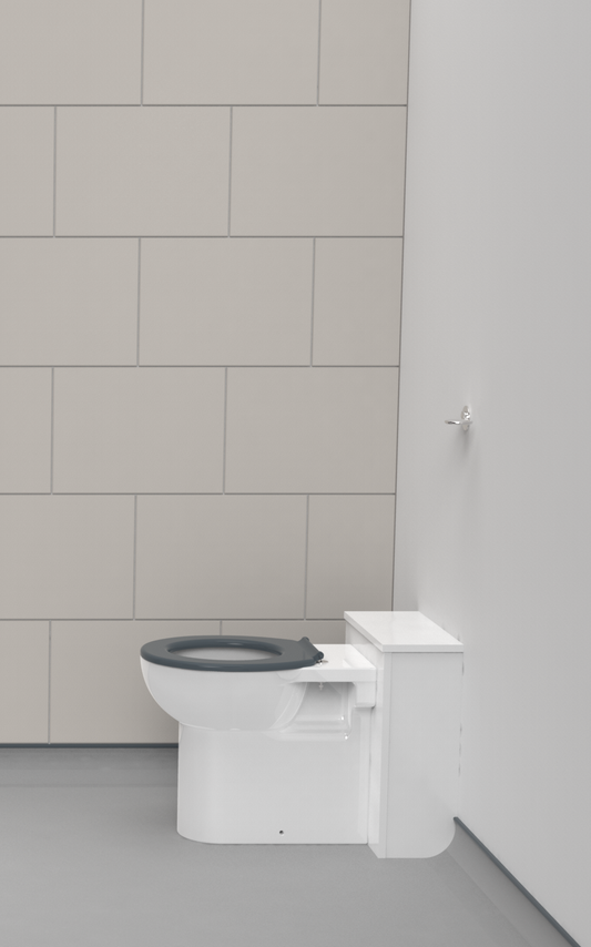 White toilet with black seat against a gray tiled wall.